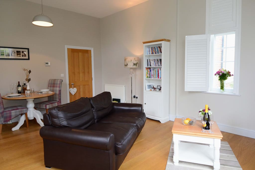 Open plan living-dining-kitchen with wood floors