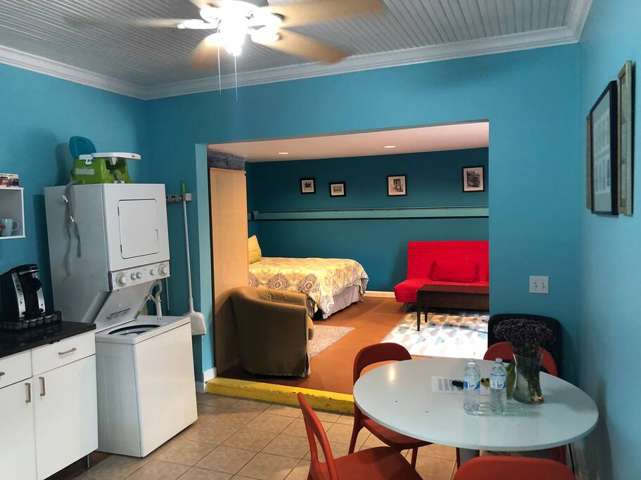 This is kitchen area looking into the common room bedroom. washer/dryer in the unit with plenty of laundry soap, ceiling fan in kitchen and lights in the bedroom are on dimmer switches.