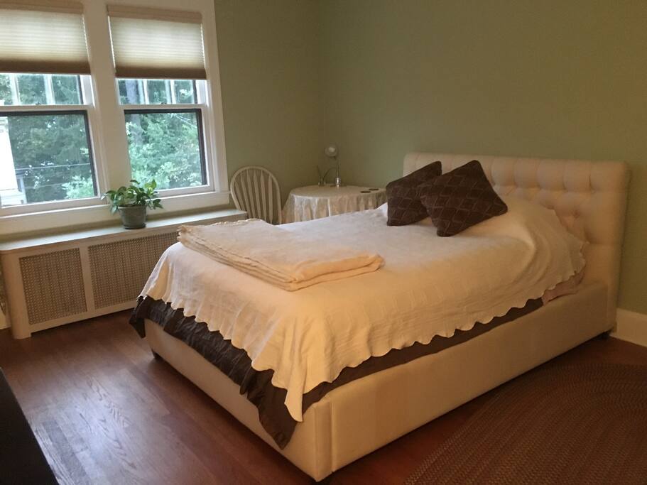 Bedroom with queen bed and river view
