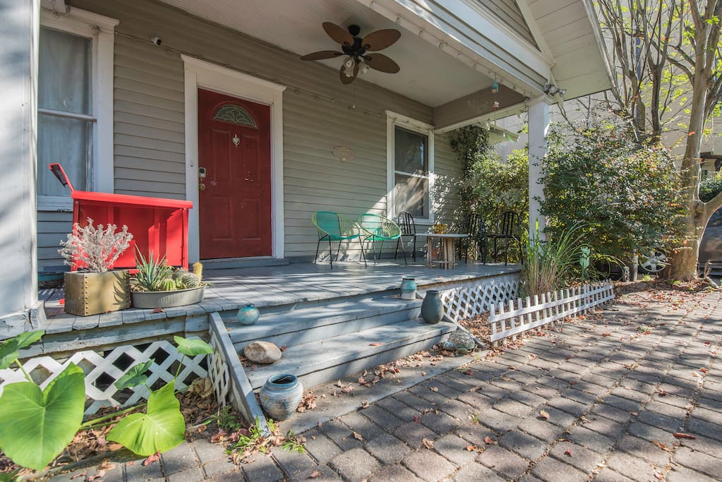 Ample amount of space on porch with several options for seating. Includes a retro glider, CB2 lounge chairs and metal Italian chairs.