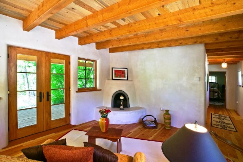 Cozy and Sunny Living Room with Kiva Fireplace and French Doors Access to Full Length Covered Porch