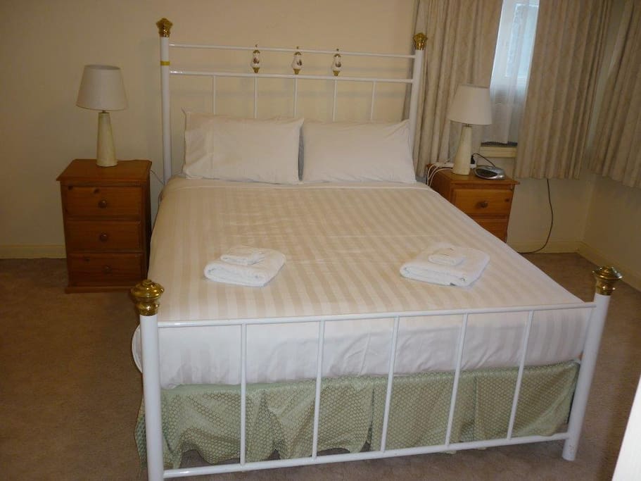 Queen size bed in the upstairs bedroom