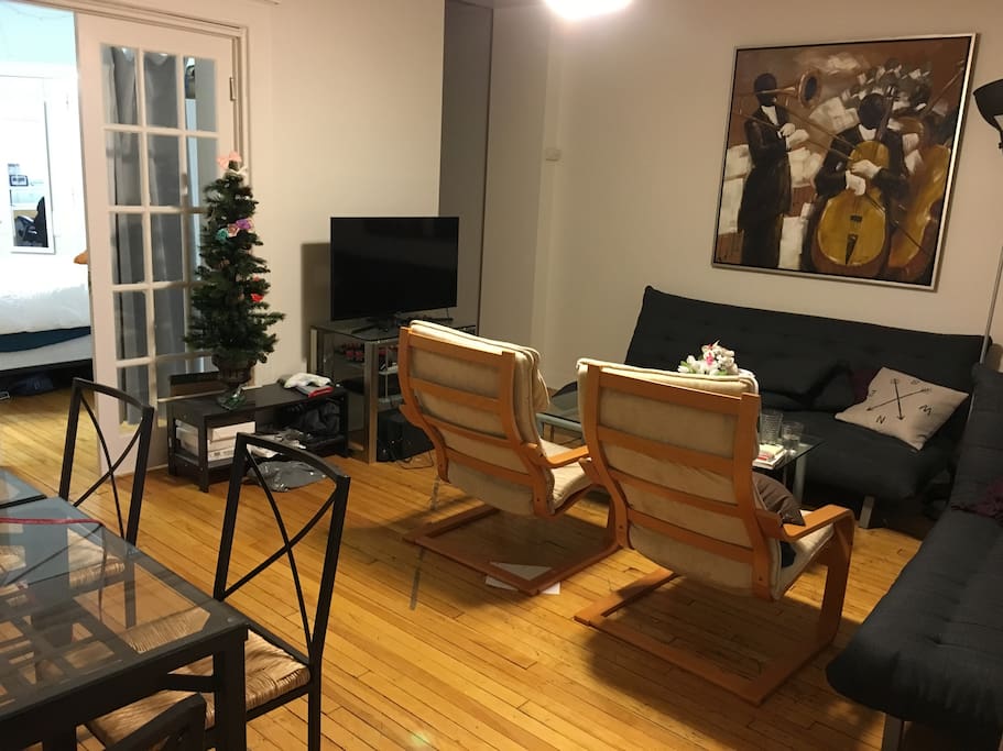 Common living/dining area with comfortable couches and smart TV