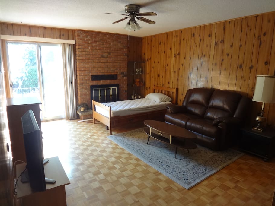 Living room with twin/single bed and direct access to backyard
