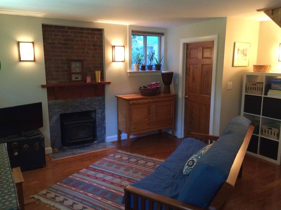 Den has a TV and a woodstove.