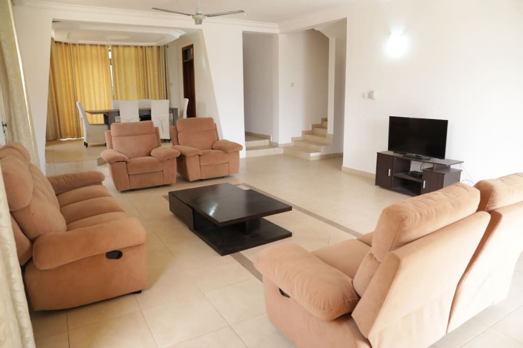 Very open and spacious living and dining area with TV and contemporary draperies