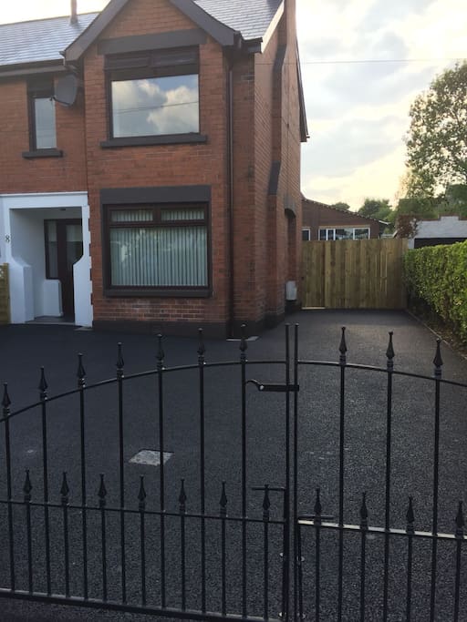 Exterior front of property which is fully enclosed and can accommodate 3+ cars. Free roadside parking also available.