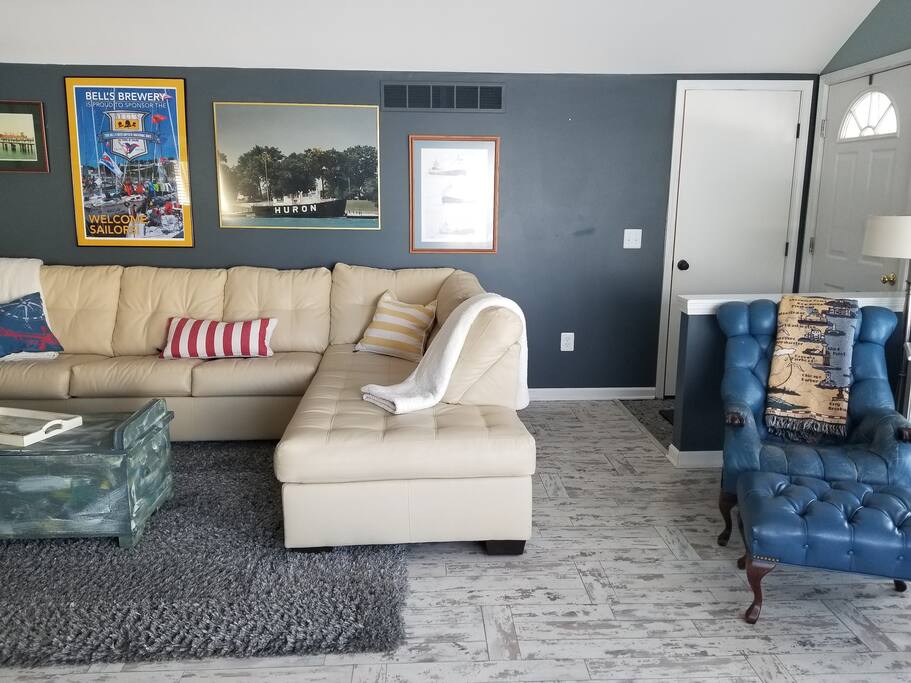 Great seating area to fireplace, lake view, and open to kitchen