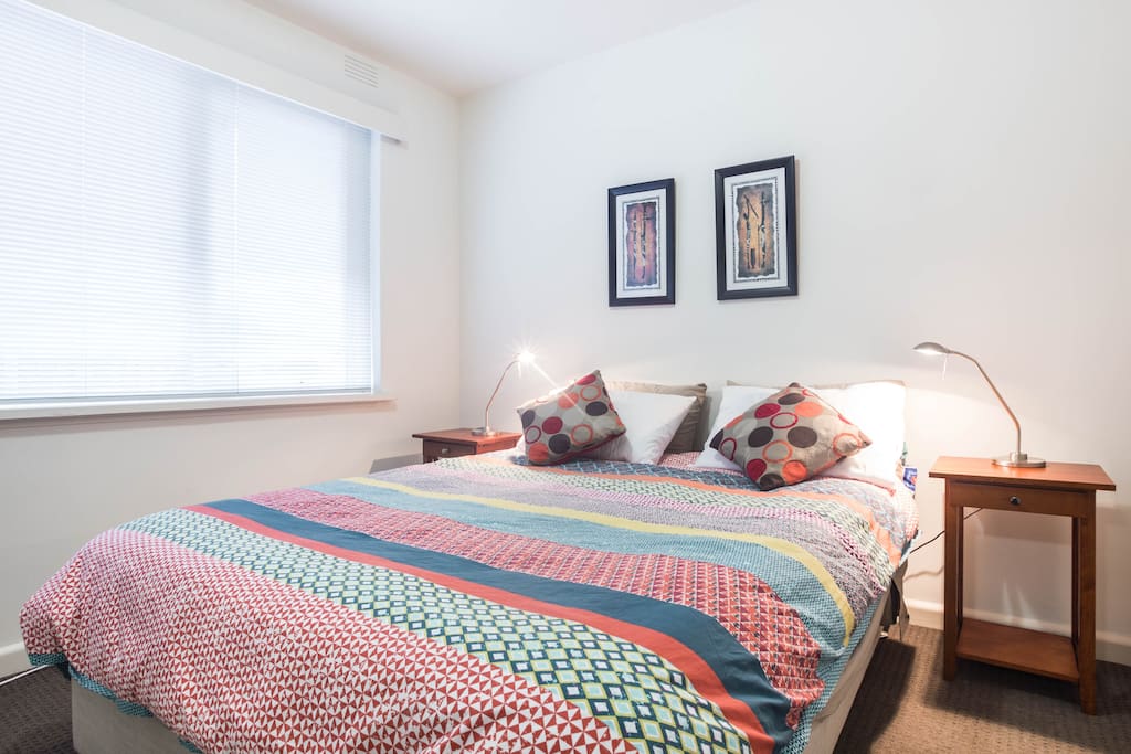 New Queen sized bed and bedding with reading lamps.