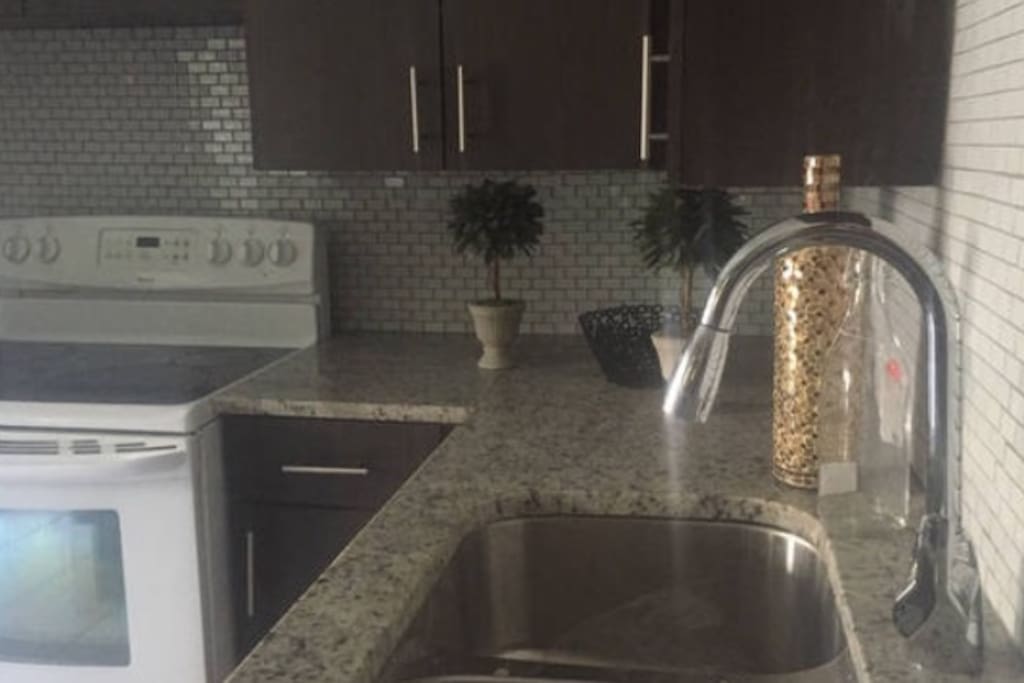 Kitchen Gorgeous renovated kitchen has granite countertops and glass tile backsplash Full size refrigerator and microwave Keurig Coffee Maker Coffee,sugar,creme included Electric stove/oven Basic dish ware Table seats up to six people