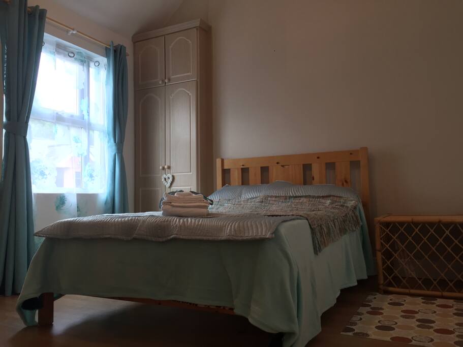 Lovely spacious bedroom with high ceiling and double bed.