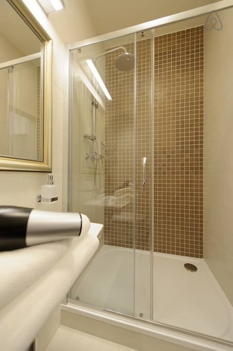 A spacious rainfall shower, perfect for relaxing after a long day full of...