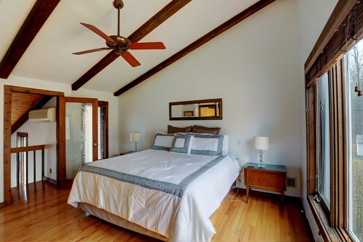 The Master bedroom with king bed.  Huge windows frame the woods outside. Ensuite master bath and walk-in closet are just out of frame. Brand new Tempur-pedic mattress.  Choice of soft or firm pillows.