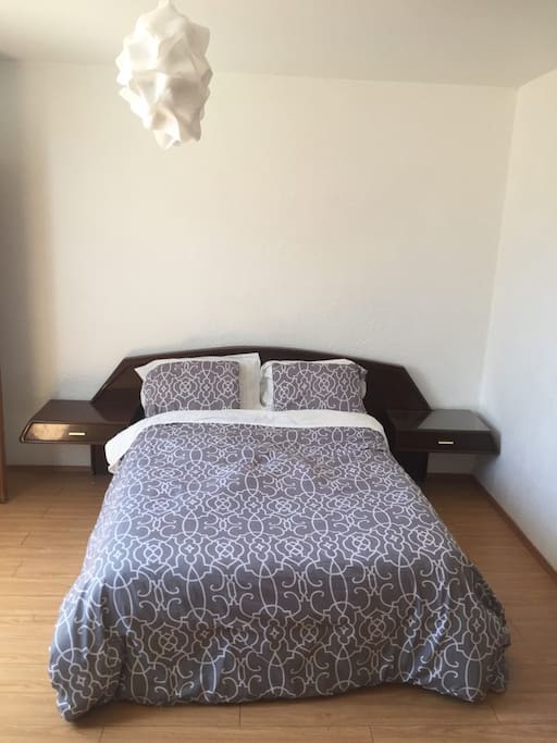 Comfortable queen size bed with side tabel/drawers