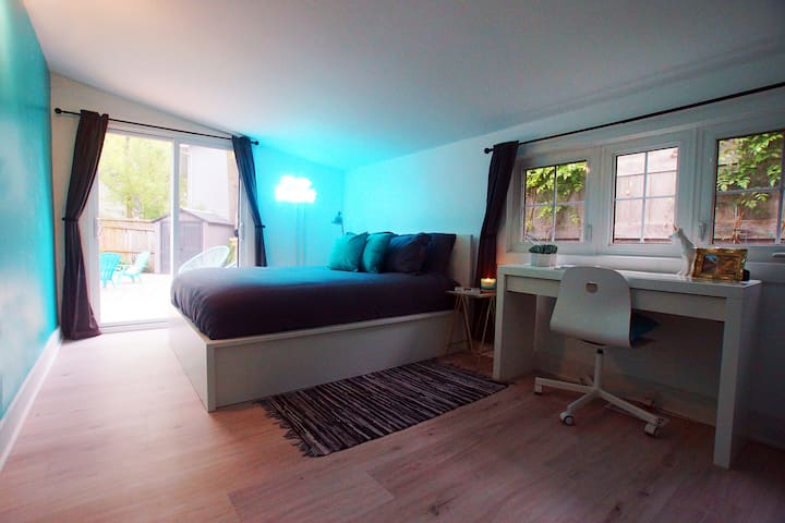 Bedroom 1 with Queen Size Bed and direct access to outside patio area and working desk.