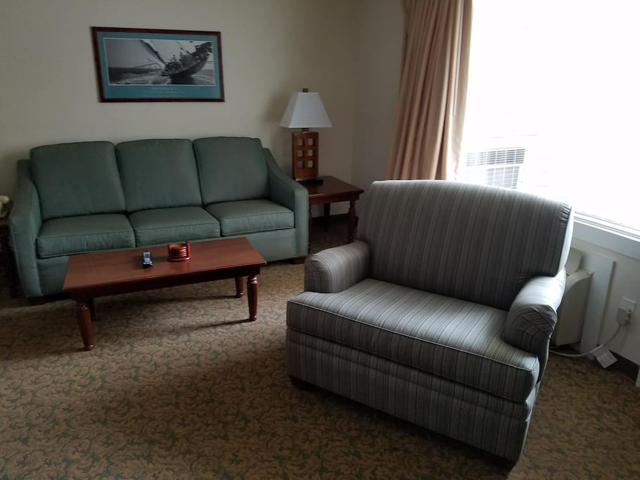 Living room with queen sleeper sofa and 2 twin bed pullout chairs