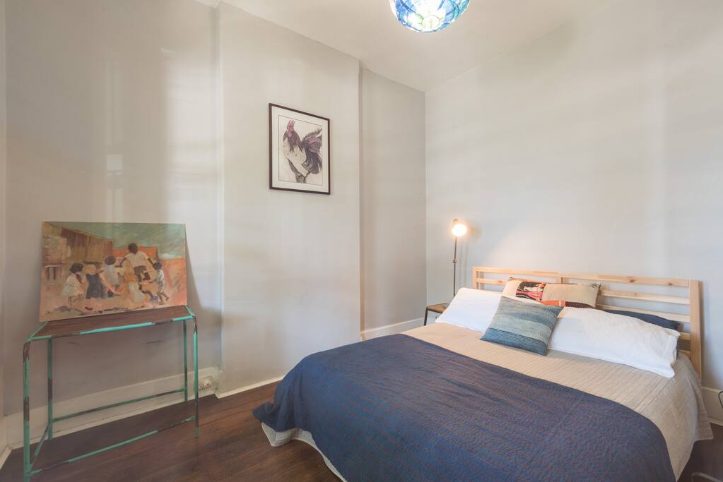 Room with Queen Bed, desk and hanging space at the front of the terrace.