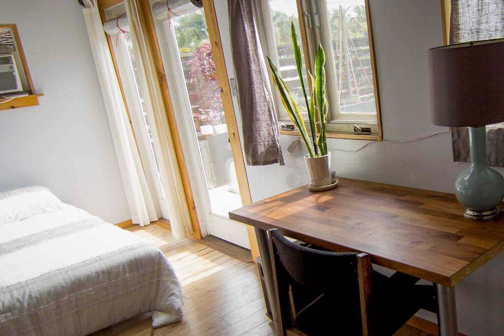 Desk and bed looking from kitchenette