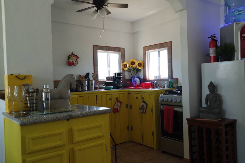 Full kitchen with utensils and modern appliances.