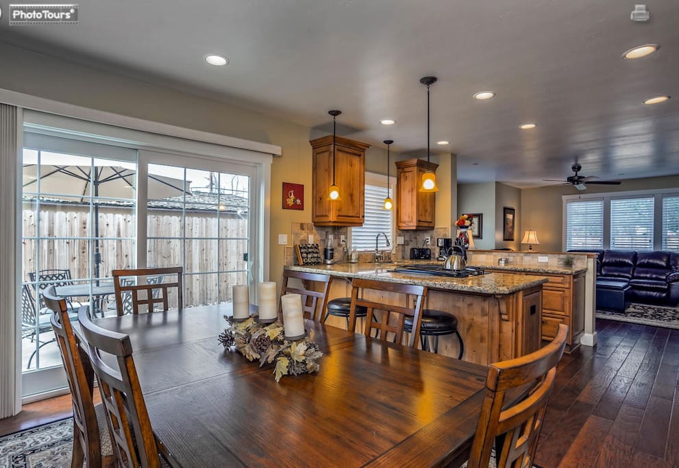 Open kitchen and dining area. Granite counter tops & engineered wood floors.