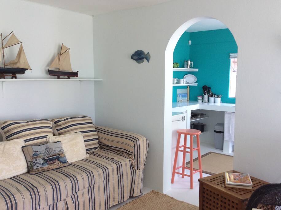 Open plan living are and kitchen with access to a small garden, and deck through large sliding doors.