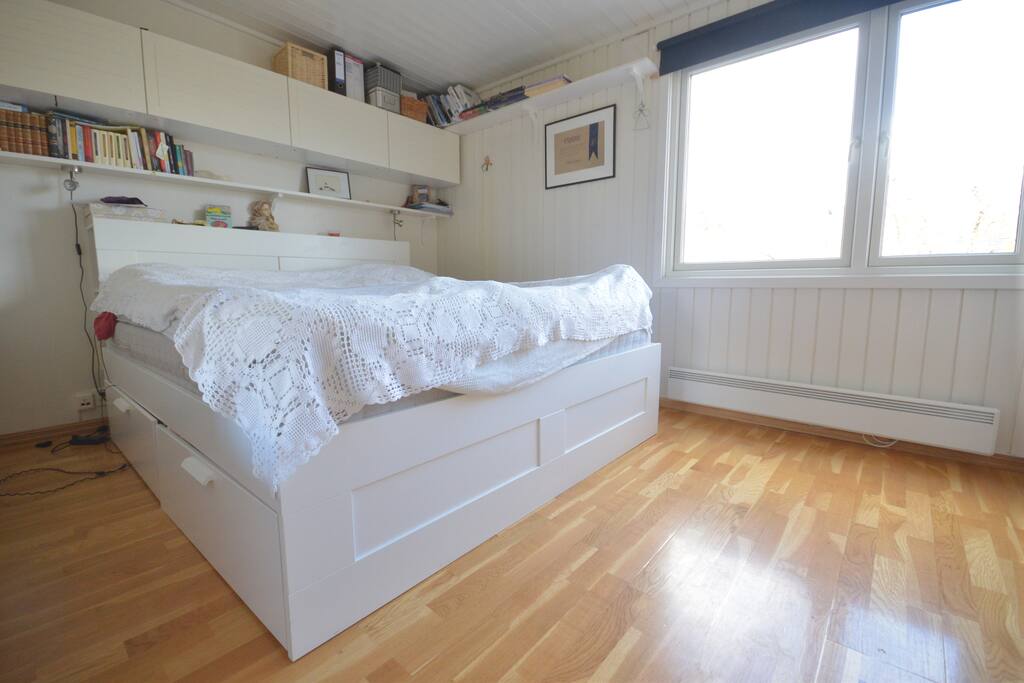 Master bedroom (1) with a tall king size bed.