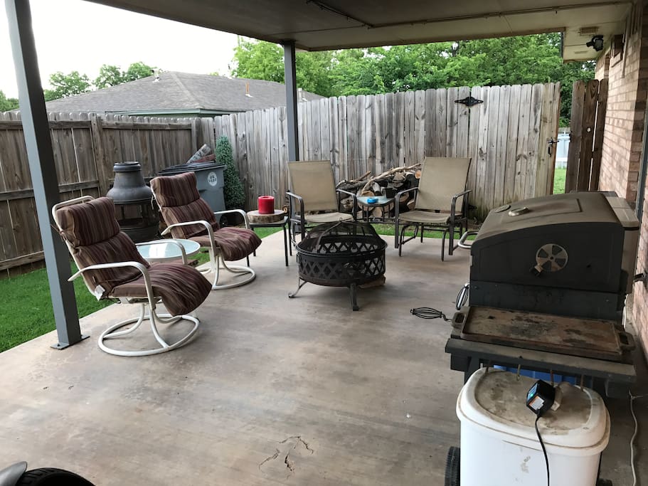 Outdoor sitting area with fire pit and BBQ
