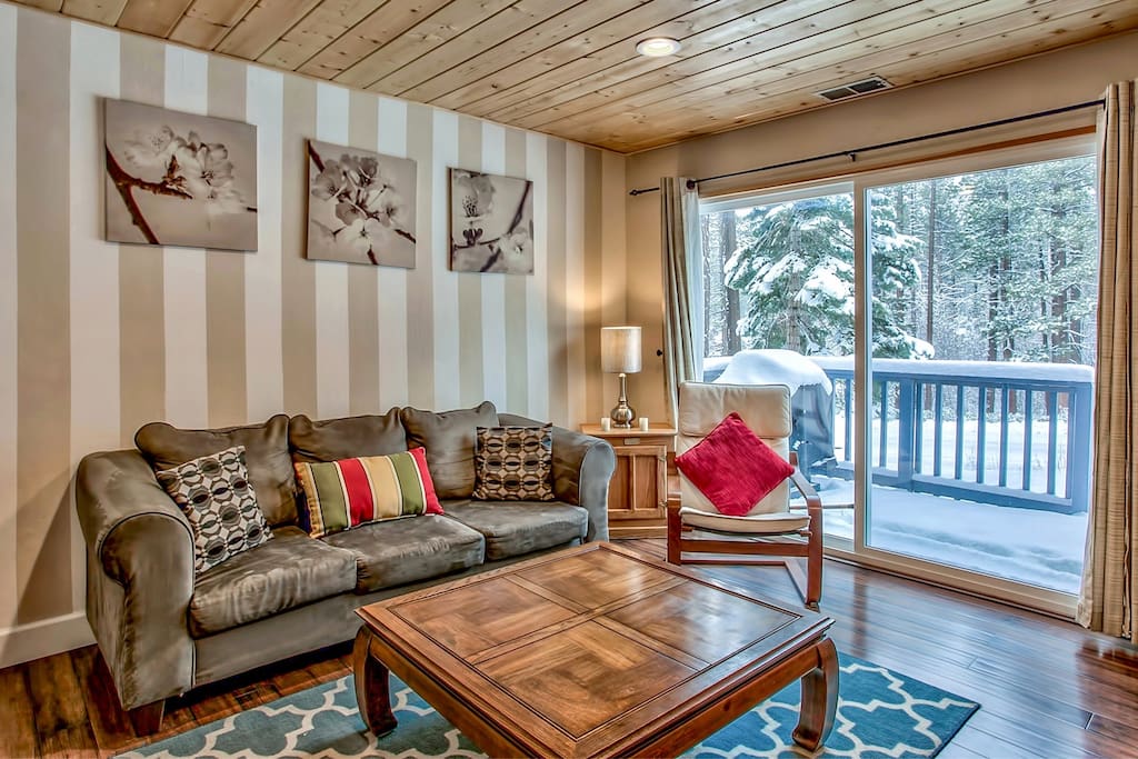 A nice cozy living room with cable tv, thermostat gas fire place and lots of board games in an open living style. (photo taken with a wide angle lens to cover more space)