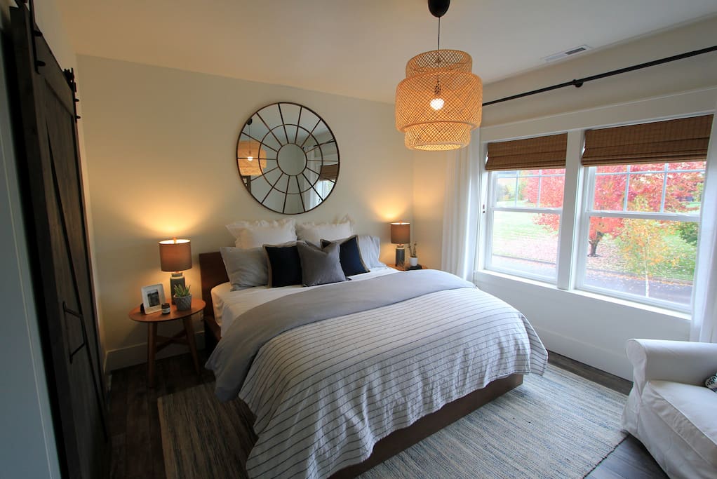 Bedroom with barn door slider. King bed, quality linens, and blackout shades make for a restful night’s sleep.