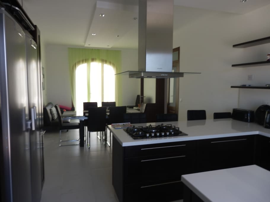 9x4 modern kitchen breakfast overlooking pool area.