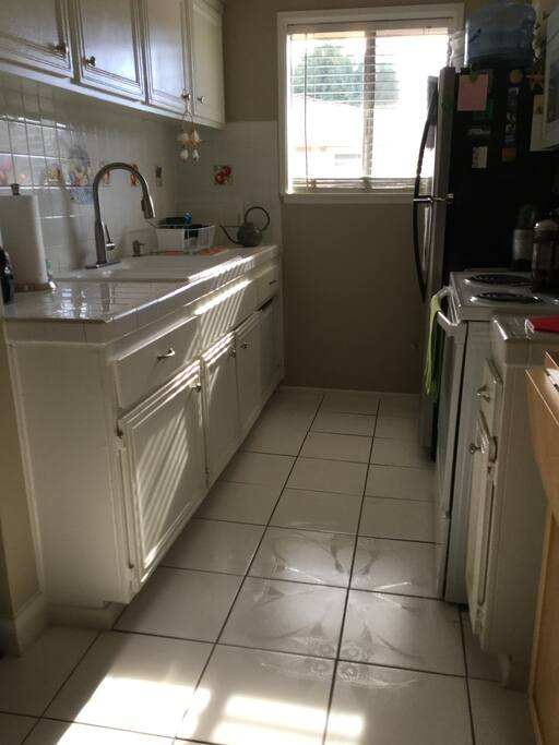 Galley kitchen with microwave and a water-saving dishwasher.