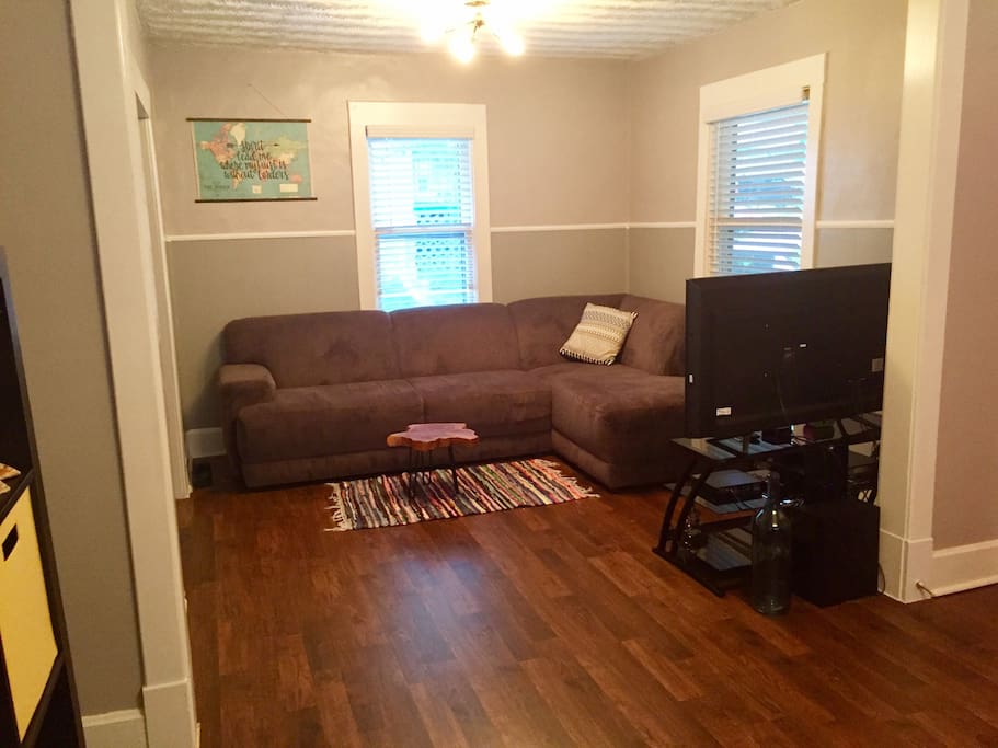 Living room with incredibly comfy couch, HDTV, DirecTV, and Roku player