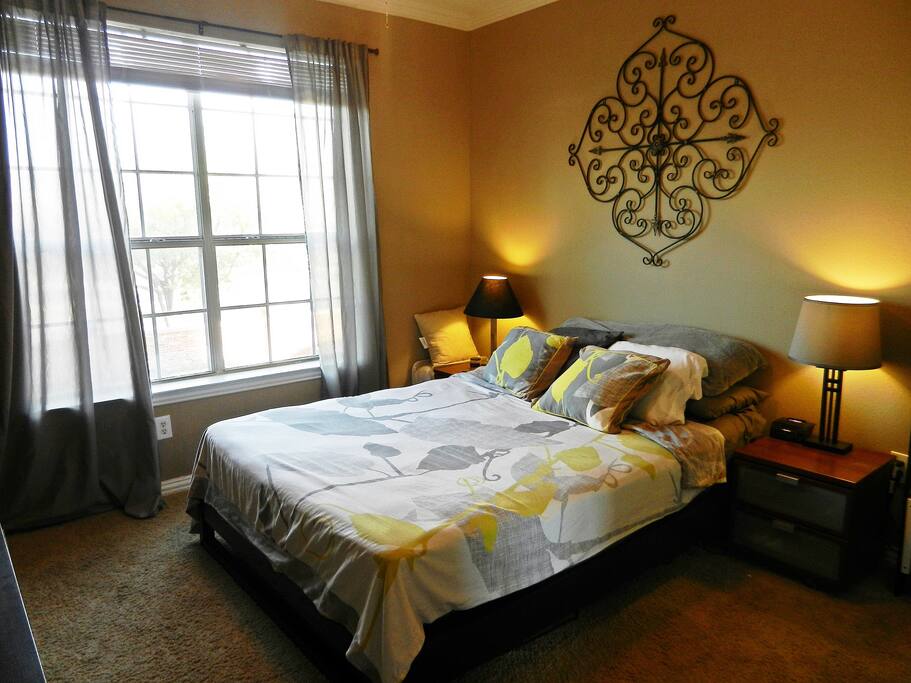 Queen size bed with TV/DVD player in room.