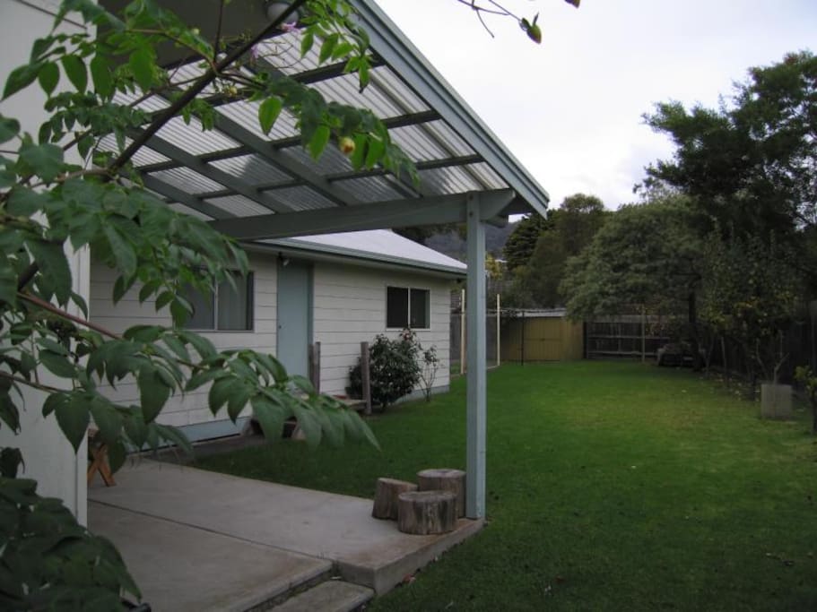 Large green backyard - outside table and chairs, beach shower, large gas BBQ