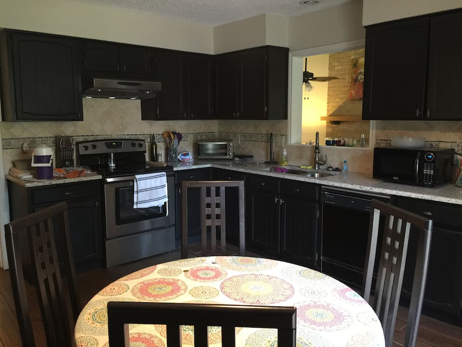 Kitchen equipped with access to stove, refrigerator, dishwasher, microwave and coffee maker.
