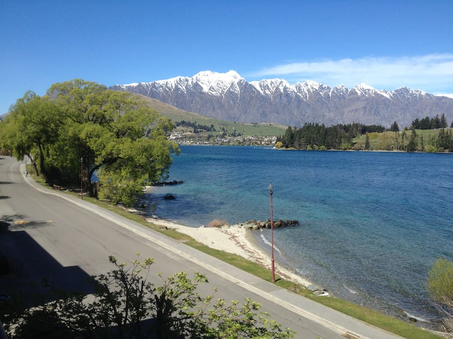 Beach directly across the road and snow on the Remarkables. Photo from house.
