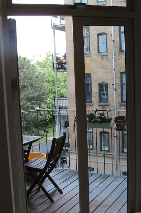 Balcony facing a quiet green yard