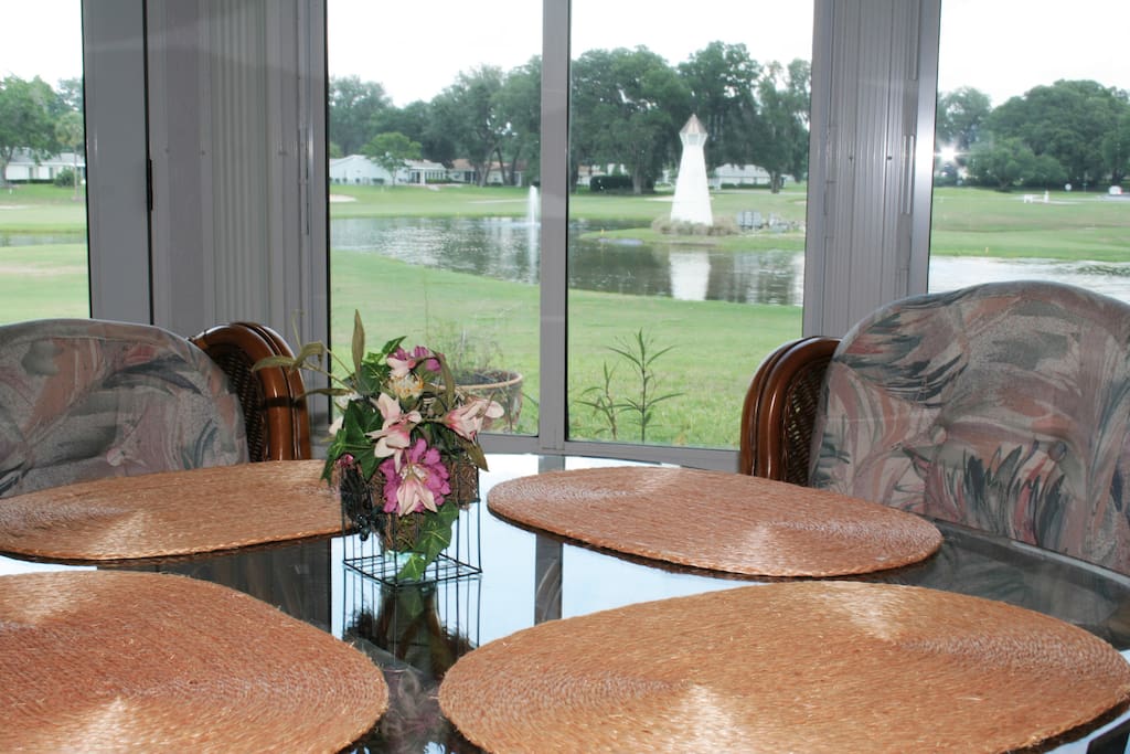 View of pond off dining area in all season Florida room