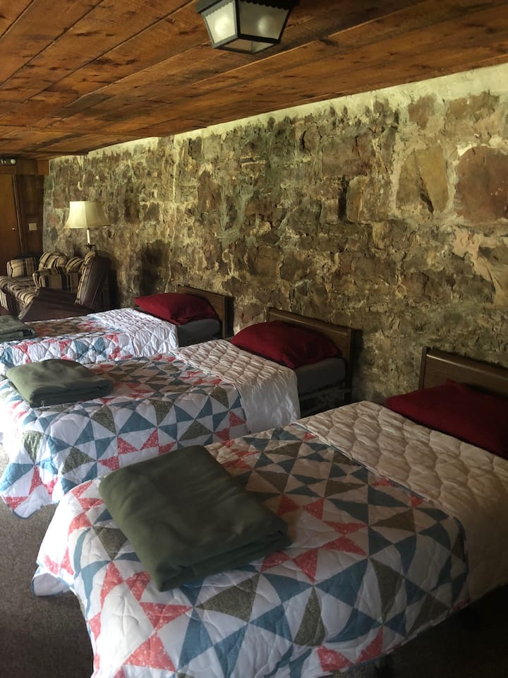 The lower floor features three single beds.