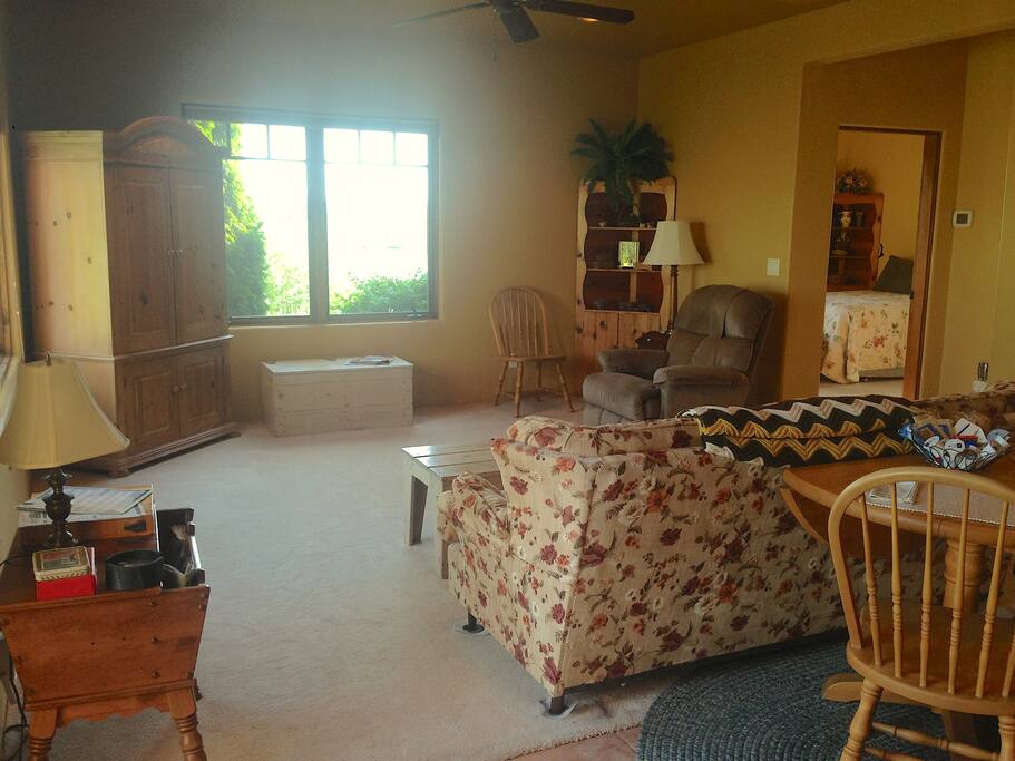 Large living room with ceiling fan and DISH TV