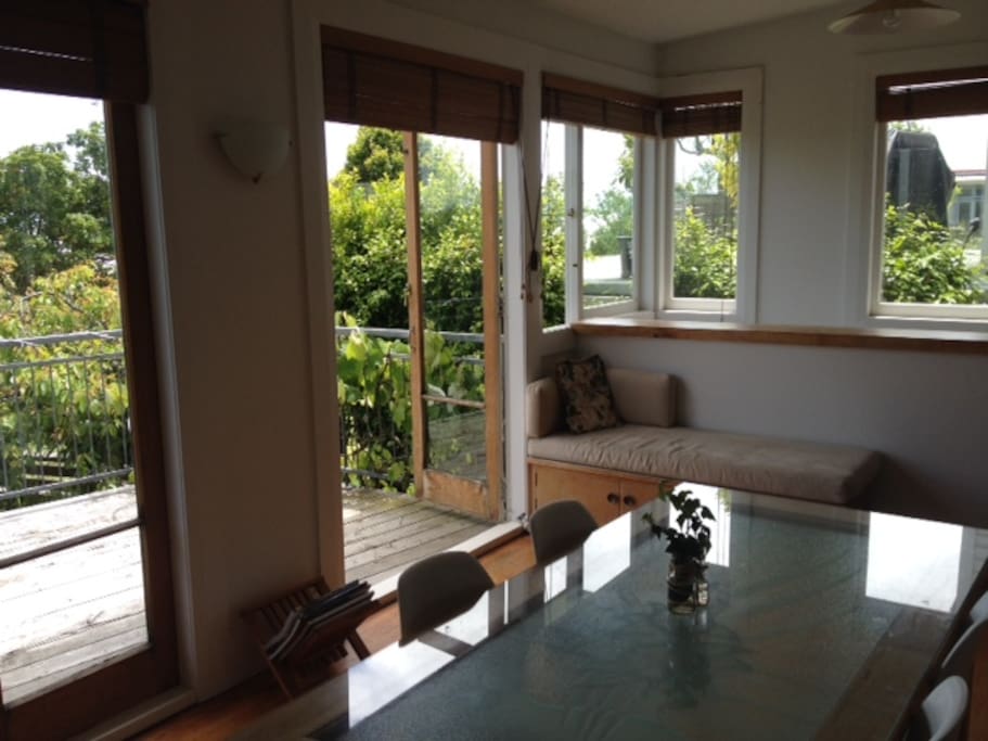 Dining Room with french doors opening to sun drenched deck