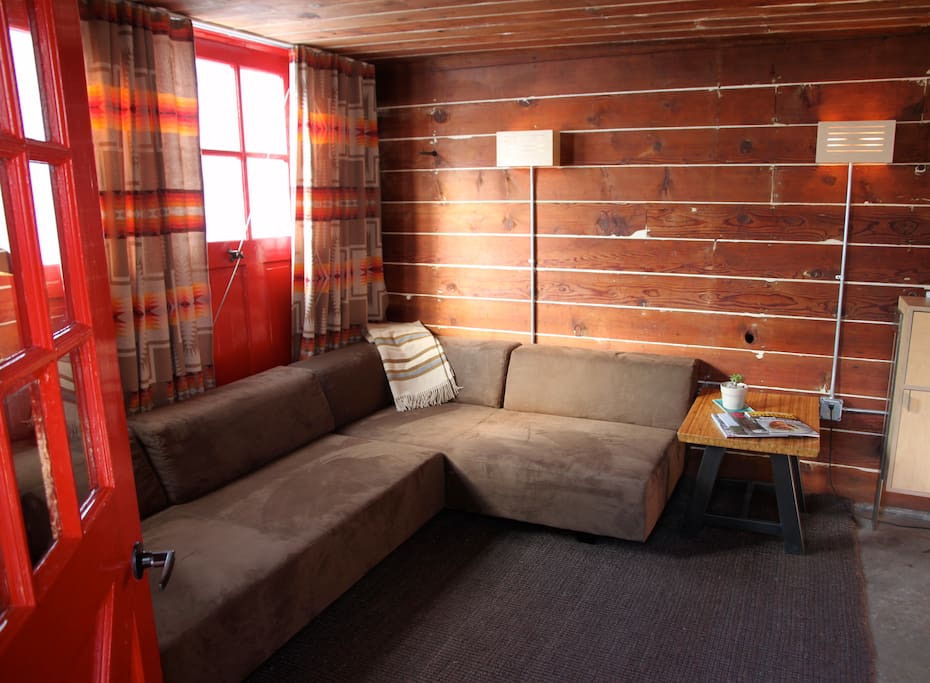 Fine Details: sanded plaster/plank walls, Pendleton curtains and throws, custom furniture