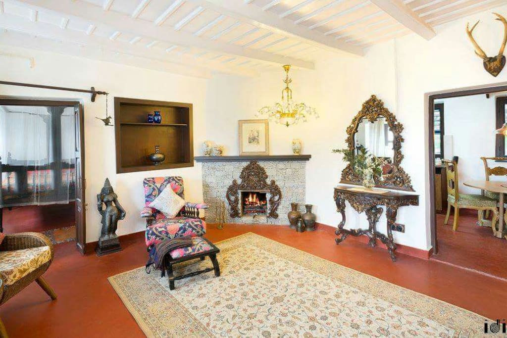 Living room with fire place console , good earth furniture coffee table and antiques.