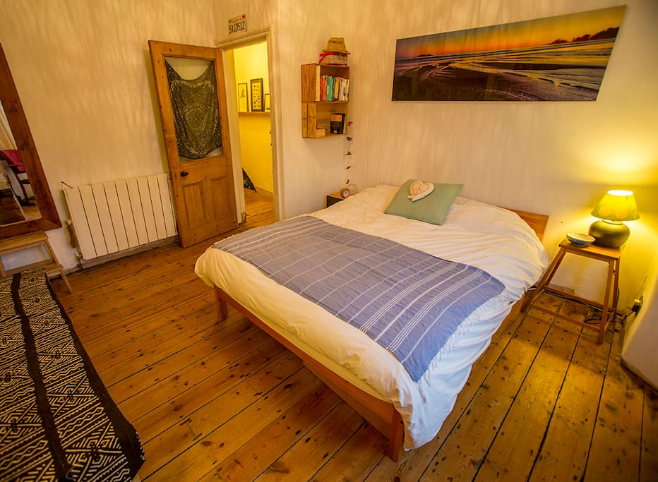 Bright airy bedroom with a king size bed with drawers and hanging space available