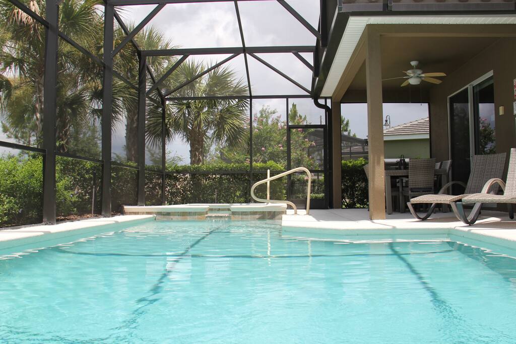 Relaxing setting by the pool with a lovely view of the palm trees