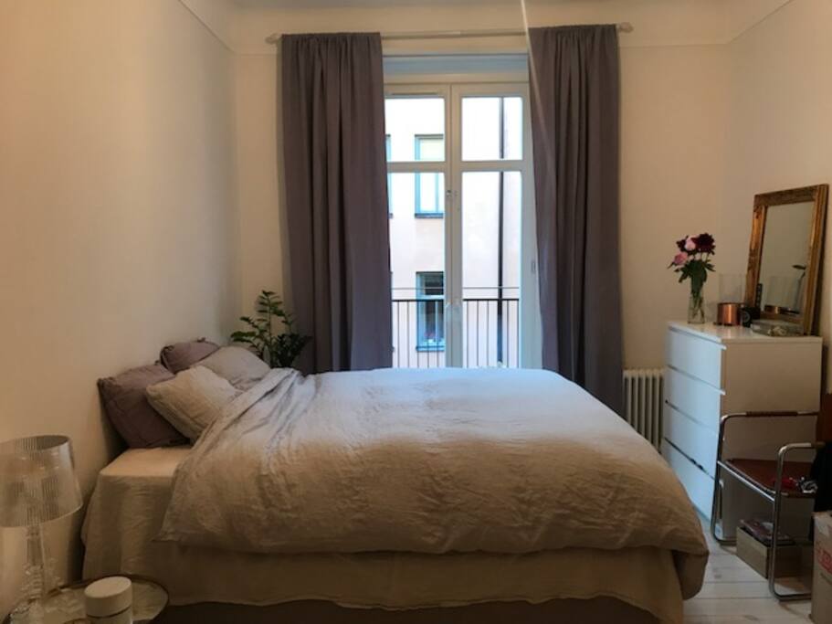 Cozy bedroom with a balcony.