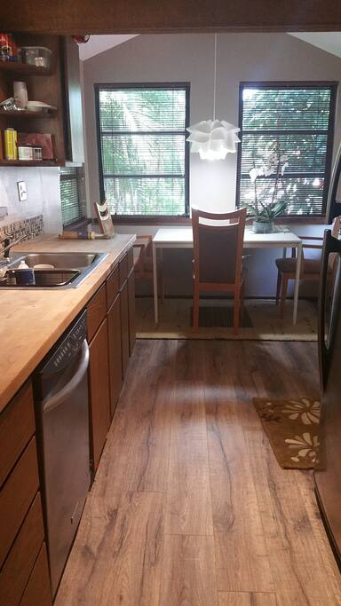 Full-size kitchen with vaulted wood-beam exposes ceilings & wood-finished flooring. Additional features include dinette, refrigerator/freezer (w/ice maker), electric stove & oven, microwave and disposal. Enjoy a tree-house vibe in nearly every room with sway palms through the windows. Kitchen is fully equipped with dish ware, pots & pans, grill supplies, silverware, coffee supplies and basic condiments.