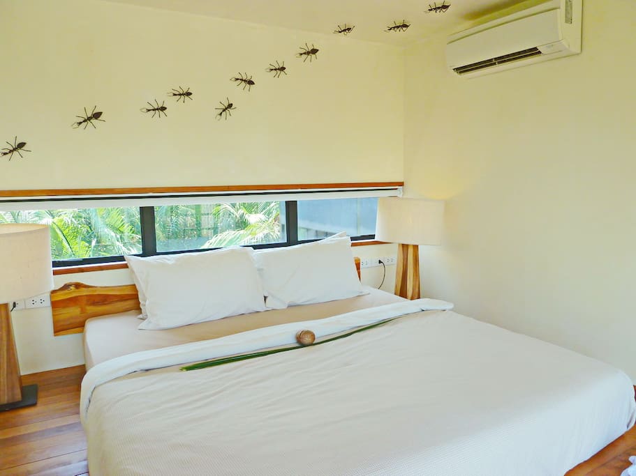 The coziest bed-nest with artwork ants about the room.