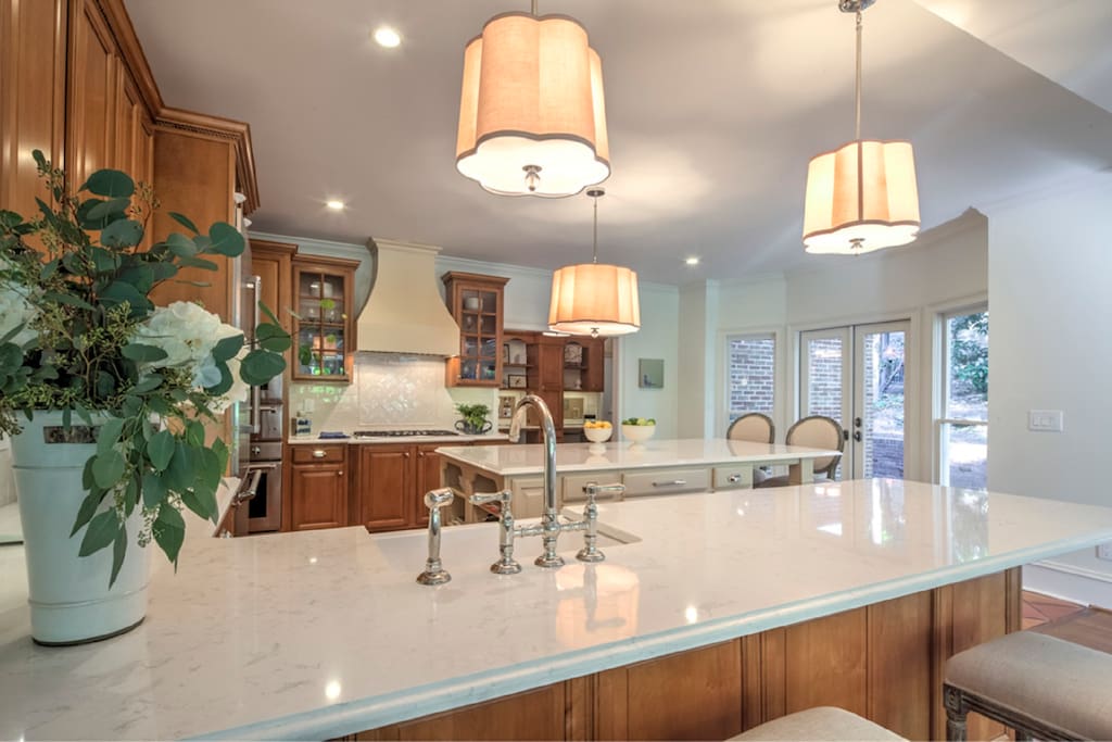 Beautiful sunlit kitchen completely renovated with new with all gourmet appliances - open to the family room and the terraces.