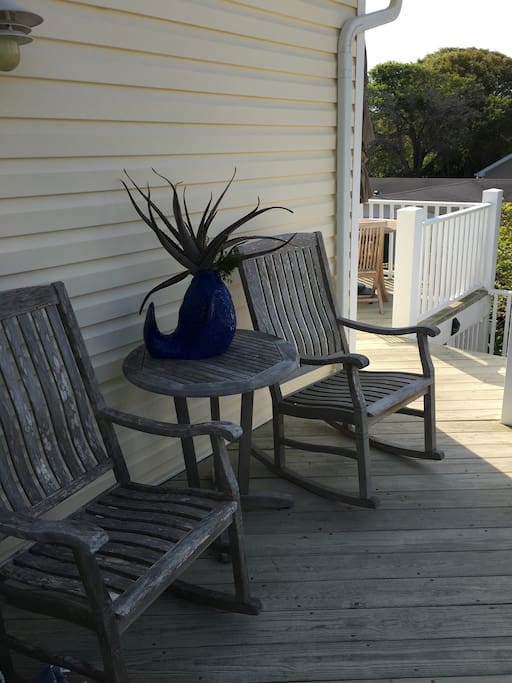 Upper decks with dining table accented by large umbrella and comfortable rocking chairs makes fot pleasant evening dining